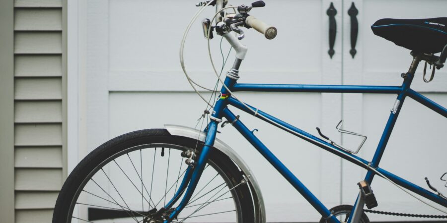 A bicycle in front of a garage or storage shed door.