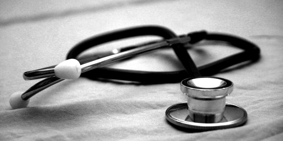 A close up, black and white picture of a doctor's stethoscope.